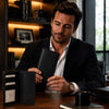 Man holding an Exclusive Vertical Bifold Wallet made of premium Italian leather in an elegant office setting.