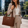 Woman in a business suit holding a Women's Business Bag in a modern urban setting.