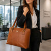 Women's Business Bag in premium Italian leather, styled by a woman in a business suit in a modern office.