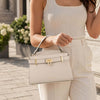 Womens Leather Tote Bag held by a model outdoors, showcasing its chic design and elegant appeal.