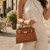 Womens Leather Tote Bag held by a woman, showcasing its elegant design and practical features in an outdoor setting.
