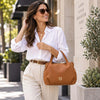 Woman Walking In The Street With The Cognac Womens Bag