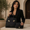 Womens Leather Handbag and Toiletry Case Set displayed by a model in a stylish outfit.