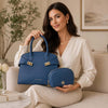 Womens Leather Handbag and Toiletry Case Set displayed by a woman in a stylish outfit.