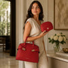 Womens Leather Handbag and Toiletry Case Set displayed by a model in elegant attire.