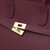 Close-up of a Womens Leather Shopper Bag featuring a gold-plated clasp and textured bordeaux leather.