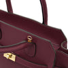 Close-up of the Womens Leather Shopper Bag in bordeaux showcasing luxurious pebbled leather and elegant handles and shoulder strap connection
