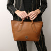 Woman Holding The Cognac Womens Leather Tote