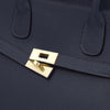 Close-up of a Womens Leather Shopper Bag featuring a gold-plated clasp and textured dark blue leather.
