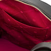 Interior view of the Woven Leather Backpack showcasing the red lining and pocket design.