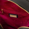 Interior view of the Woven Leather Backpack featuring a zip pocket and elegant red lining.