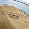Interior view of a Woven Leather Backpack featuring a zippered pocket and soft lining.