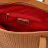 Interior view of the woven leather shopping bag featuring a red lining and zip pocket, ideal for organization.
