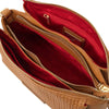 Interior compartments of the Woven Leather Shoulder Bag featuring a zipped section and vibrant red lining.