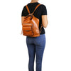 Women Posing with Backpack View Of The Cognac Convertible Leather Handbag