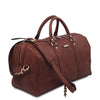 Angled And Shoulder Strap View Of The Brown Leather Travel Duffel Bag